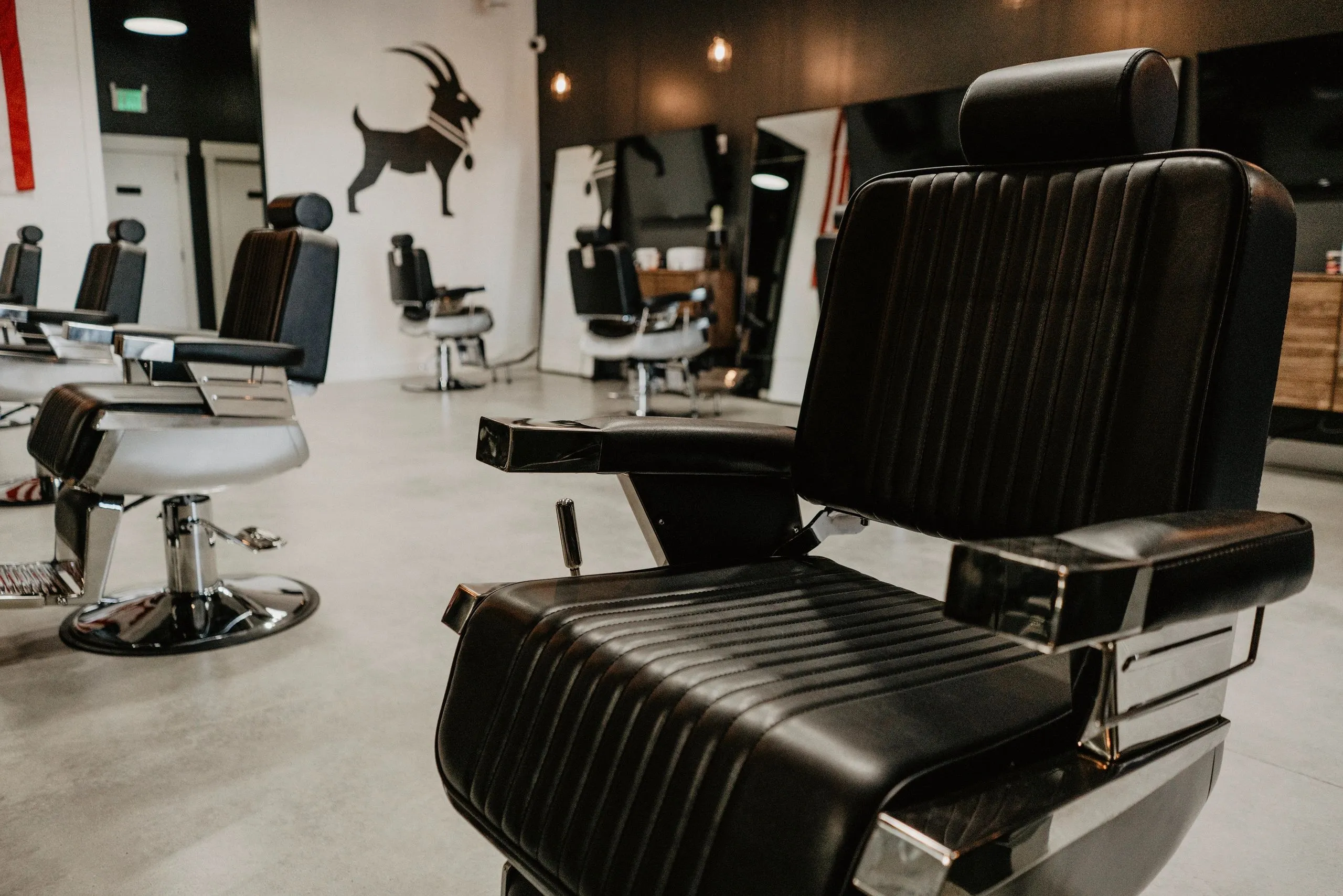 Black leather barber chair at G.O.A.T. Haircuts