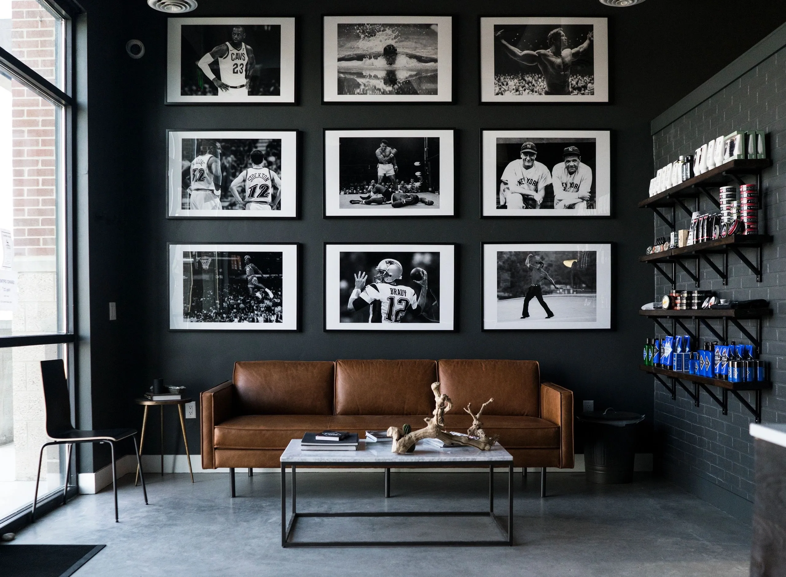 G.O.A.T. waiting lounge with leather couch and framed sports photography